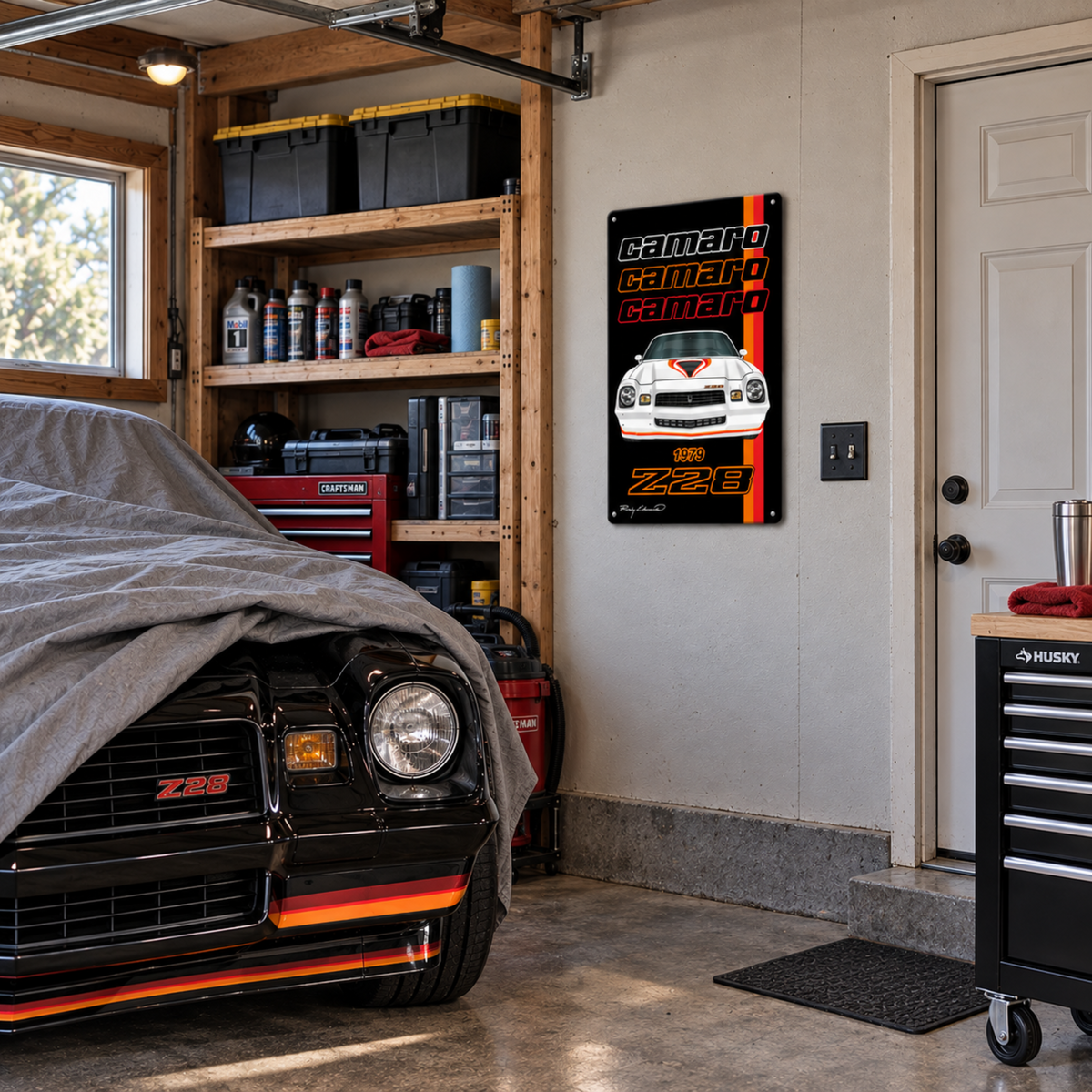 1979 Chevrolet Camaro Z28 metal sign displayed in a garage workshop above a black Camaro with tool storage and automotive décor.