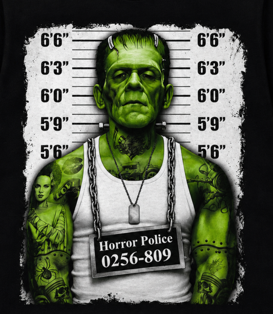 Close-up of the Frankenstein Monster Mugshot black T-shirt showing his green face, neck bolts, height chart and prisoner placard in the horror design.