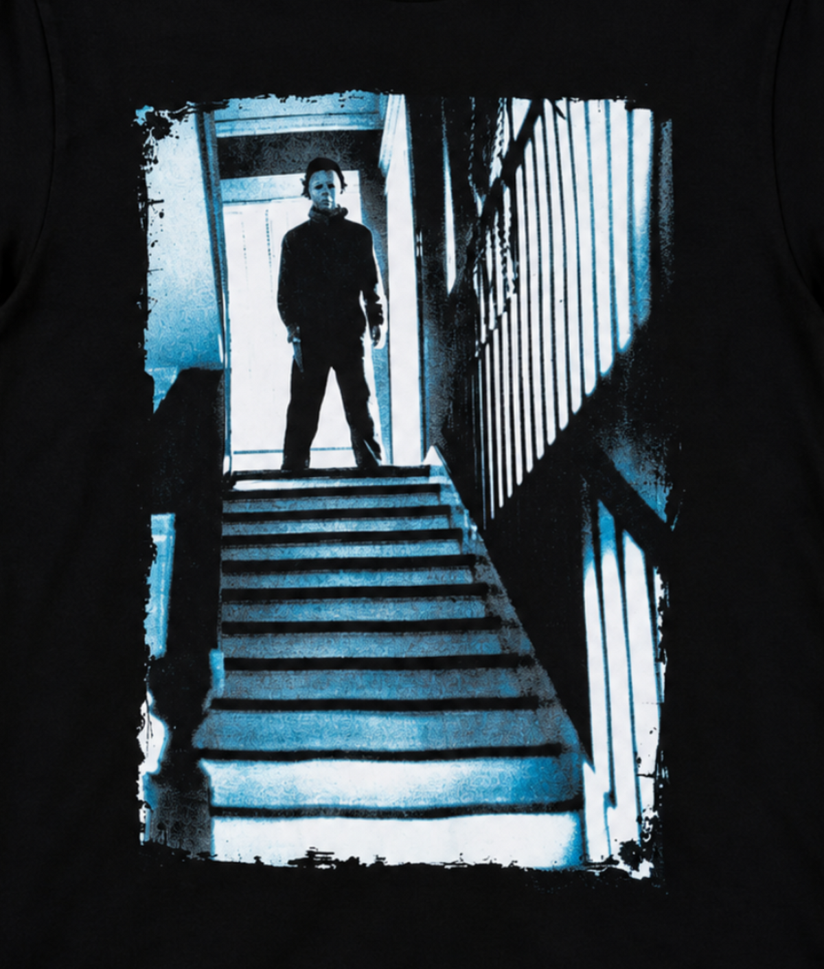 Close-up of Michael Myers standing motionless at the top of the staircase, framed by a bright doorway in the Halloween horror graphic.