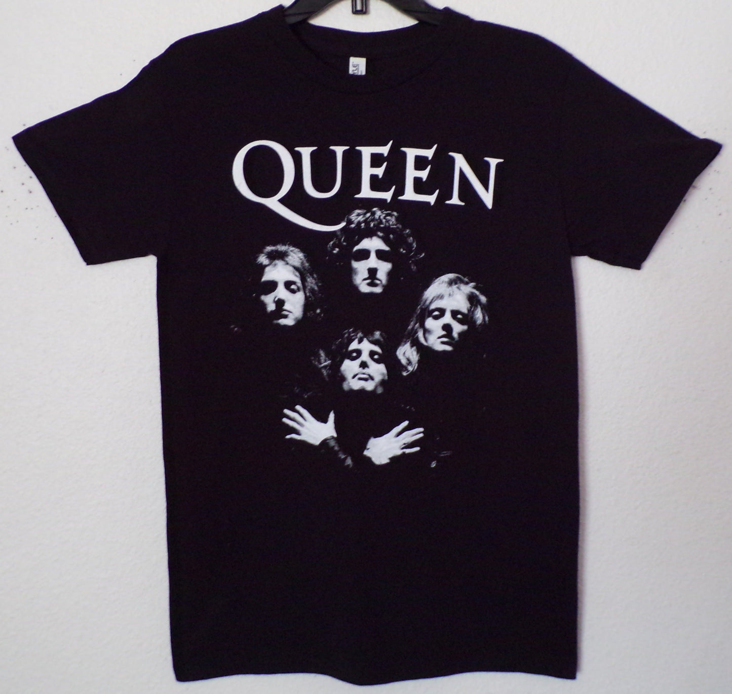 A unisex silkscreen t-shirt featuring bold artwork inspired by Queen's iconic "Bohemian Rhapsody" song. The design captures the vibrant energy of the classic anthem, perfect for rock fans. Available in sizes Small-2XL.