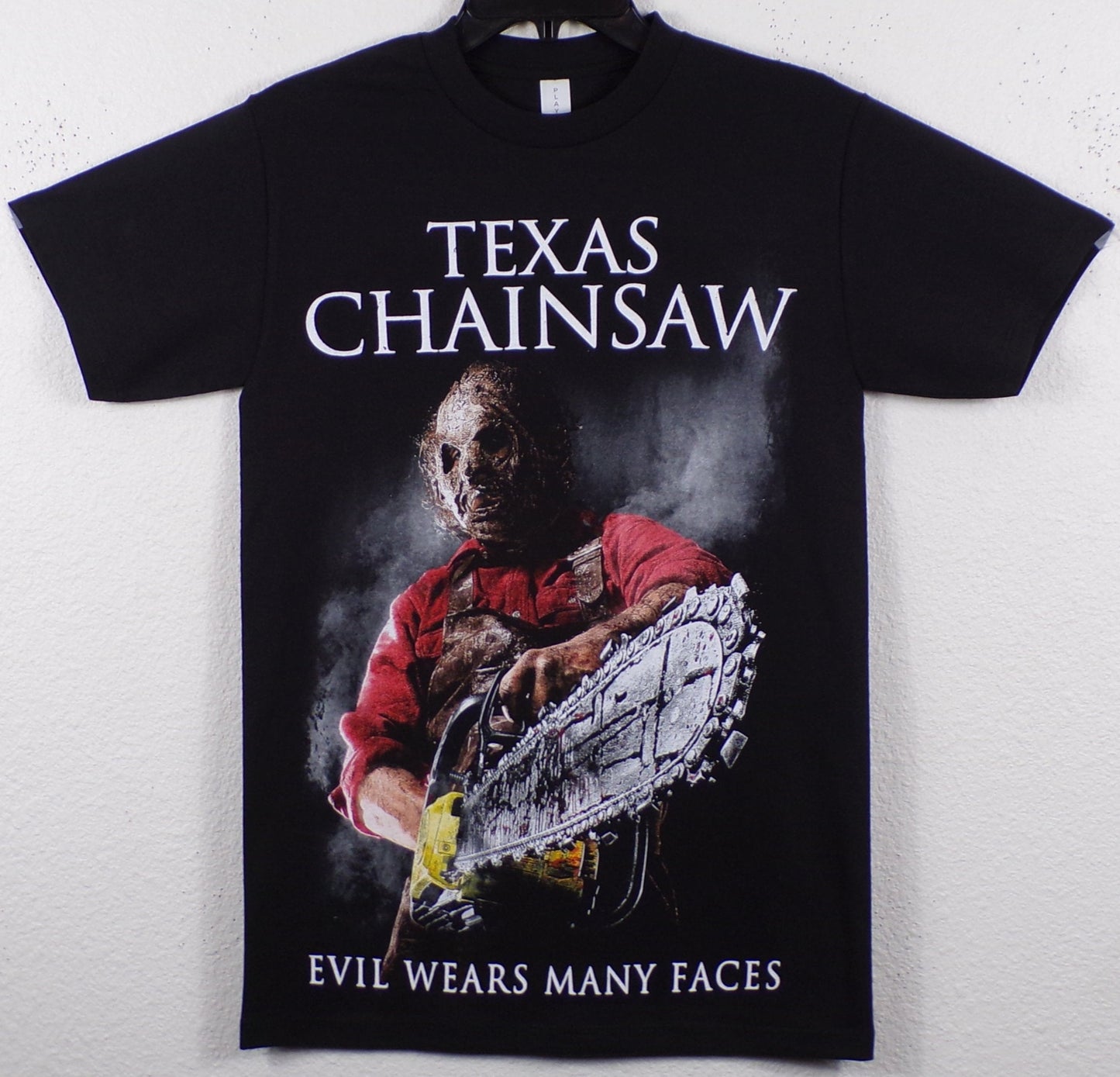 ’The Texas Chain Saw Massacre - Evil Wears Many Faces’ Adult Silkscreen T-Shirt. Available From Small-3XL.
