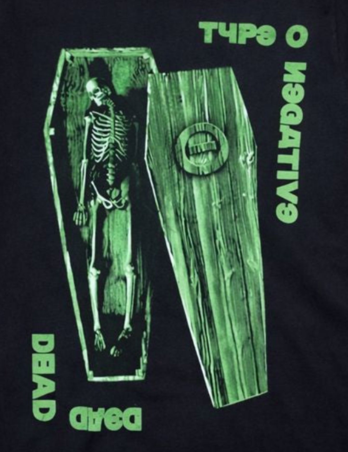 Front view of Type O Negative Dead Again T-shirt featuring green skeleton and coffin graphic with gothic lettering printed in authentic silkscreen detail.