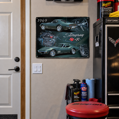 1969 Chevrolet Corvette Stingray collage metal sign mounted on a garage wall near an entry door with automotive supplies and Corvette memorabilia.