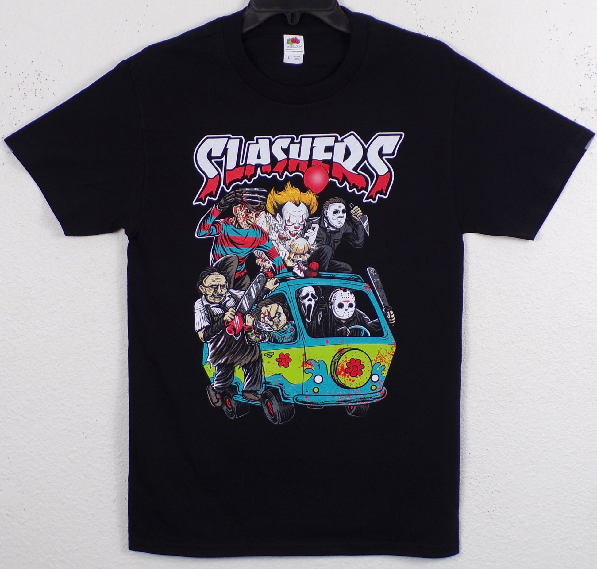 Front view of slasher horror Mystery Machine graphic T-shirt featuring Freddy Krueger, Jason, Pennywise, Chucky and other horror icons in cartoon van scene printed in authentic silkscreen on black cotton tee