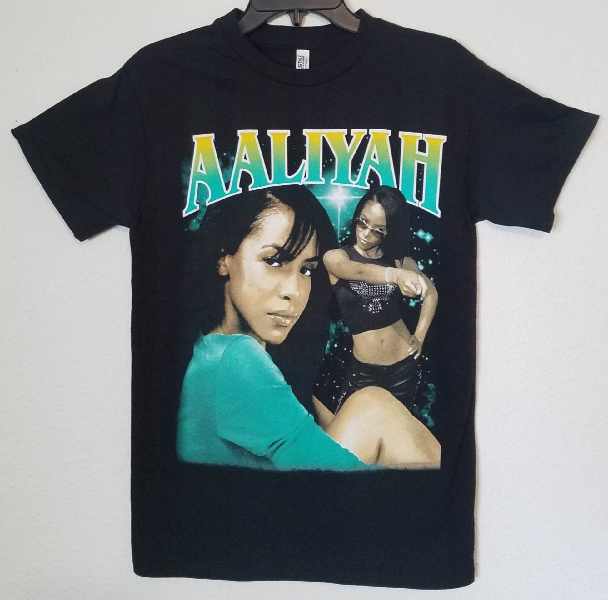 Black “Aaliyah – Green Aura” unisex T-shirt featuring a double-portrait collage with vivid green tones, Small–3XL.