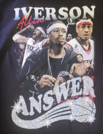 Black “Allen Iverson – The Answer” T-shirt featuring a collage of Iverson with a glitter-style logo and bold basketball tribute design.