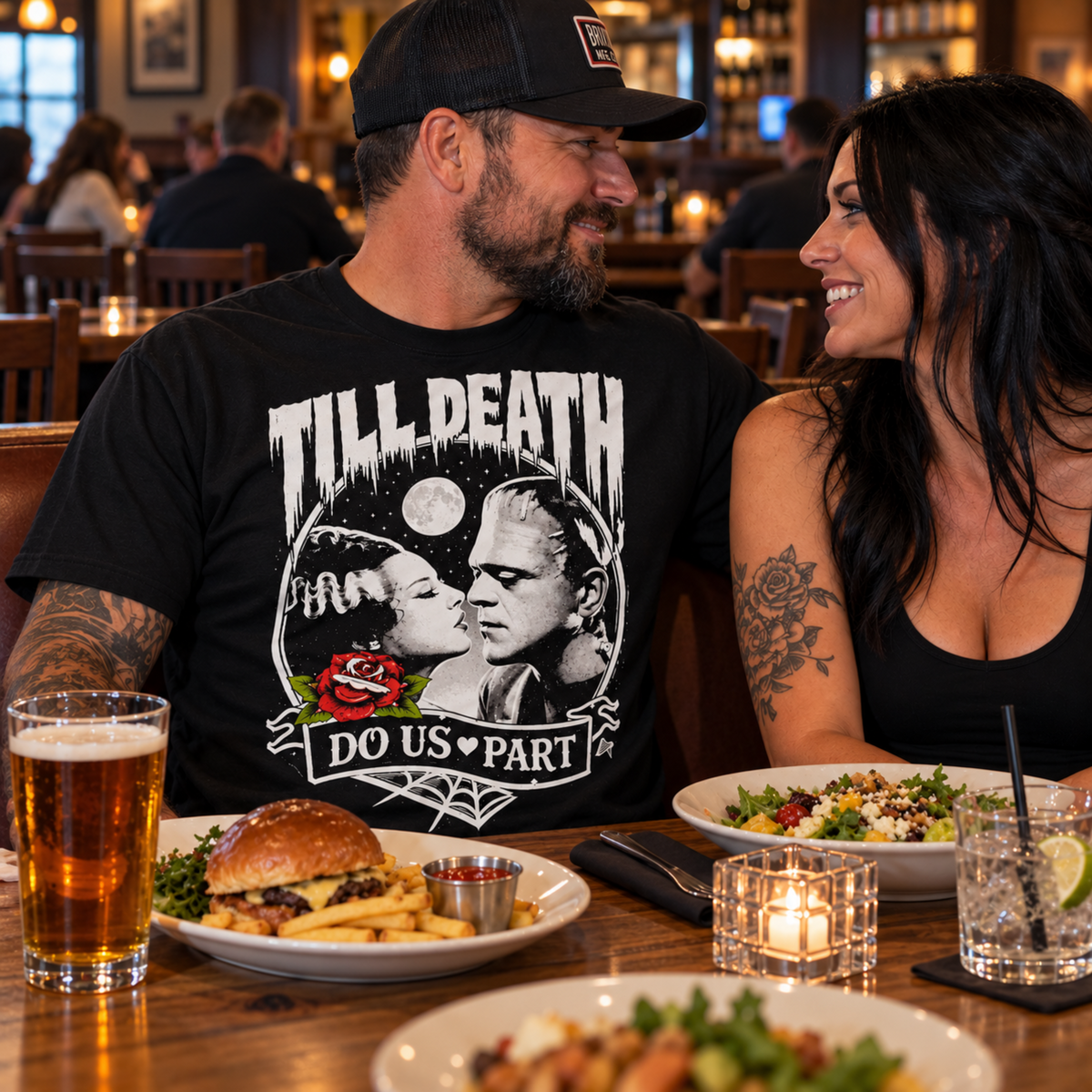 Man wearing the Till Death Do Us Part black T-shirt on a gastropub date, featuring Bride of Frankenstein and Frankenstein’s monster in the gothic romance design.
