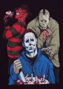 Youth T-shirt featuring a silkscreen design of Michael Myers, Freddy Krueger, and Jason Voorhees sitting around a campfire with a birthday cake. Freddy is holding a knife and a slice of cake, while Jason stands behind Michael, who is in his signature blue jumpsuit. Available in sizes XS-XL.