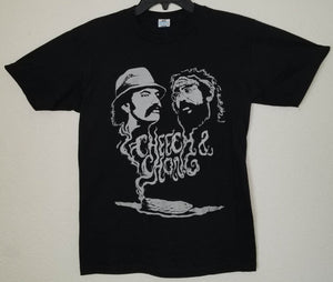 Cheech & Chong - Smoking Joint Unisex T-shirt featuring the comedy duo in a classic stoner pose, with vibrant colors and bold details capturing their playful and iconic style.