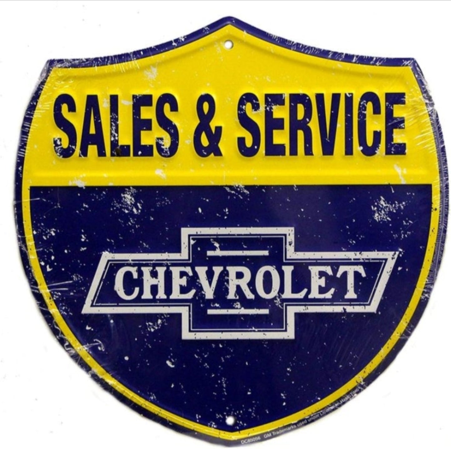 Chevrolet Sales & Service embossed shield aluminum sign featuring a classic bowtie logo inspired by mid-20th-century dealership signage, available in 12 inch and 24 inch diameter.