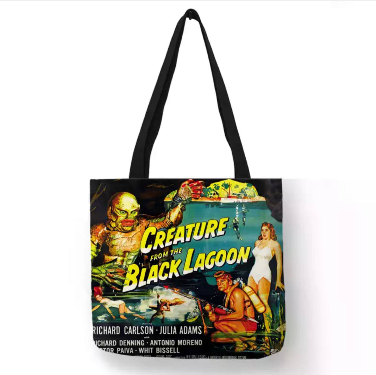 Black double-sided Creature from the Black Lagoon canvas tote bag featuring the Gill-man with one claw raised, Julie Adams in a white swimsuit, and colorful lagoon artwork.