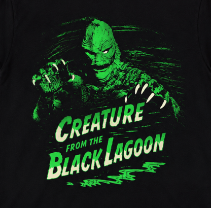 Close-up of Creature from the Black Lagoon Green Creature artwork with the Gill-man, vintage film scenes, neon-green swamp water and distressed title.