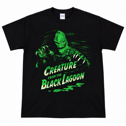 Creature from the Black Lagoon black graphic T-shirt featuring the Gill-man, layered film scenes and distressed neon-green swamp artwork.