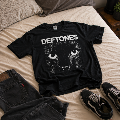 Deftones Sphynx Cat Eyes black graphic T-shirt laid out with black jeans and sneakers, highlighting the oversized cat graphic—a standout everyday tee for Deftones fans.