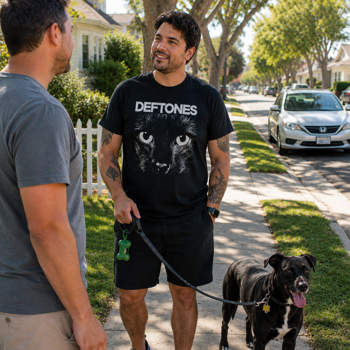 Deftones Sphynx Cat Eyes black graphic T-shirt worn while walking a dog through the neighborhood, showing how the bold cat design works as an easy everyday tee for Deftones fans.