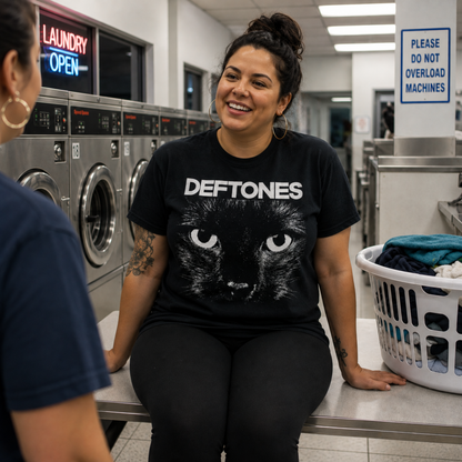 Deftones Sphynx Cat Eyes black graphic T-shirt worn at a laundromat, with the oversized cat eyes and Deftones logo standing out for a casual everyday alternative metal look.