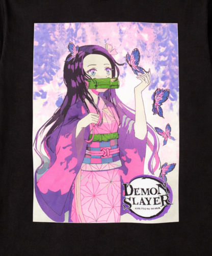 Close-up of the Demon Slayer Nezuko Kamado T-shirt featuring her pink kimono, bamboo muzzle, butterflies, and pink, purple, and lavender watercolor design.