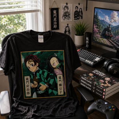 Demon Slayer Tanjiro and Nezuko Kamado black graphic T-shirt displayed at an anime gaming setup with manga and gaming gear, showing off the bold character artwork for Demon Slayer fans.