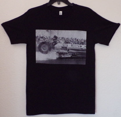 Black “Don Big Daddy Garlits – Clutch Explosion” unisex T-shirt featuring a historic black-and-white image from Lions Drag Strip, Small–3XL.