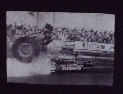 Black “Don Big Daddy Garlits – Clutch Explosion” unisex T-shirt featuring a historic black-and-white image from Lions Drag Strip, Small–3XL.