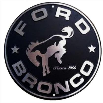 Ford Bronco embossed round aluminum sign featuring the classic Bronco logo, available in 12 inch and 24 inch diameter, ideal for garage or off-road décor.