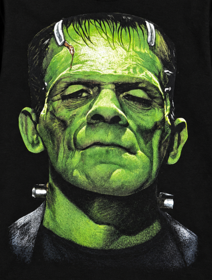 Close-up of the Frankenstein black T-shirt showing the monster’s green face, heavy brow, scars and neck bolts in detailed classic horror artwork.