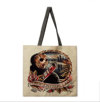 Friday the 13th Camp Crystal Lake double-sided canvas tote bag in natural beige featuring Jason Voorhees, his hockey mask, machete, and vintage campground artwork.
