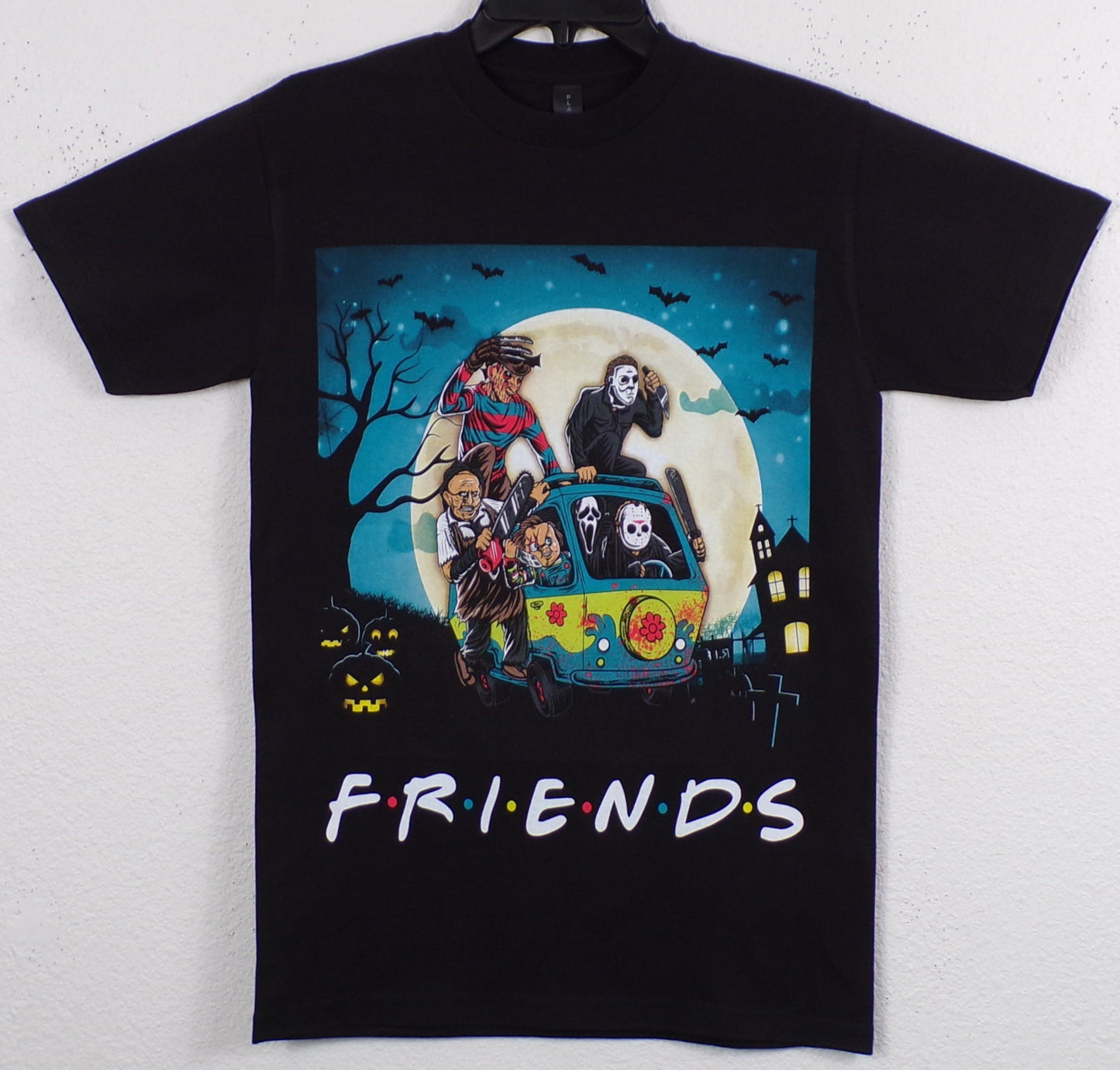 Unisex F R I E N D S Horror Mystery Machine T-shirt featuring slasher icons Freddy Krueger, Pennywise IT, Jason Voorhees, Leatherface, Chucky, Ghostface, and Michael Myers in a dynamic design.