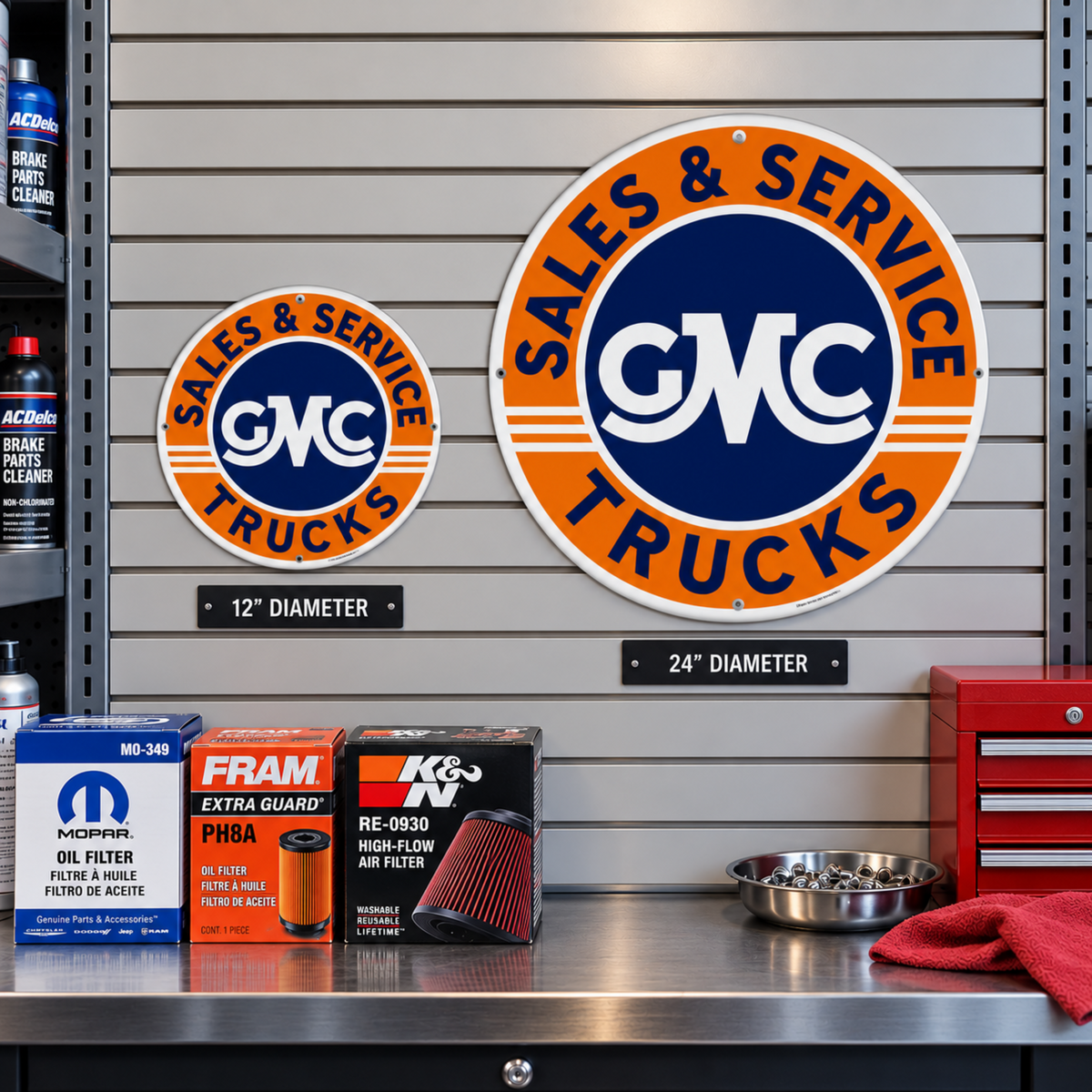 GMC Trucks Sales & Service embossed aluminum signs shown together in 12" and 24" diameter sizes.