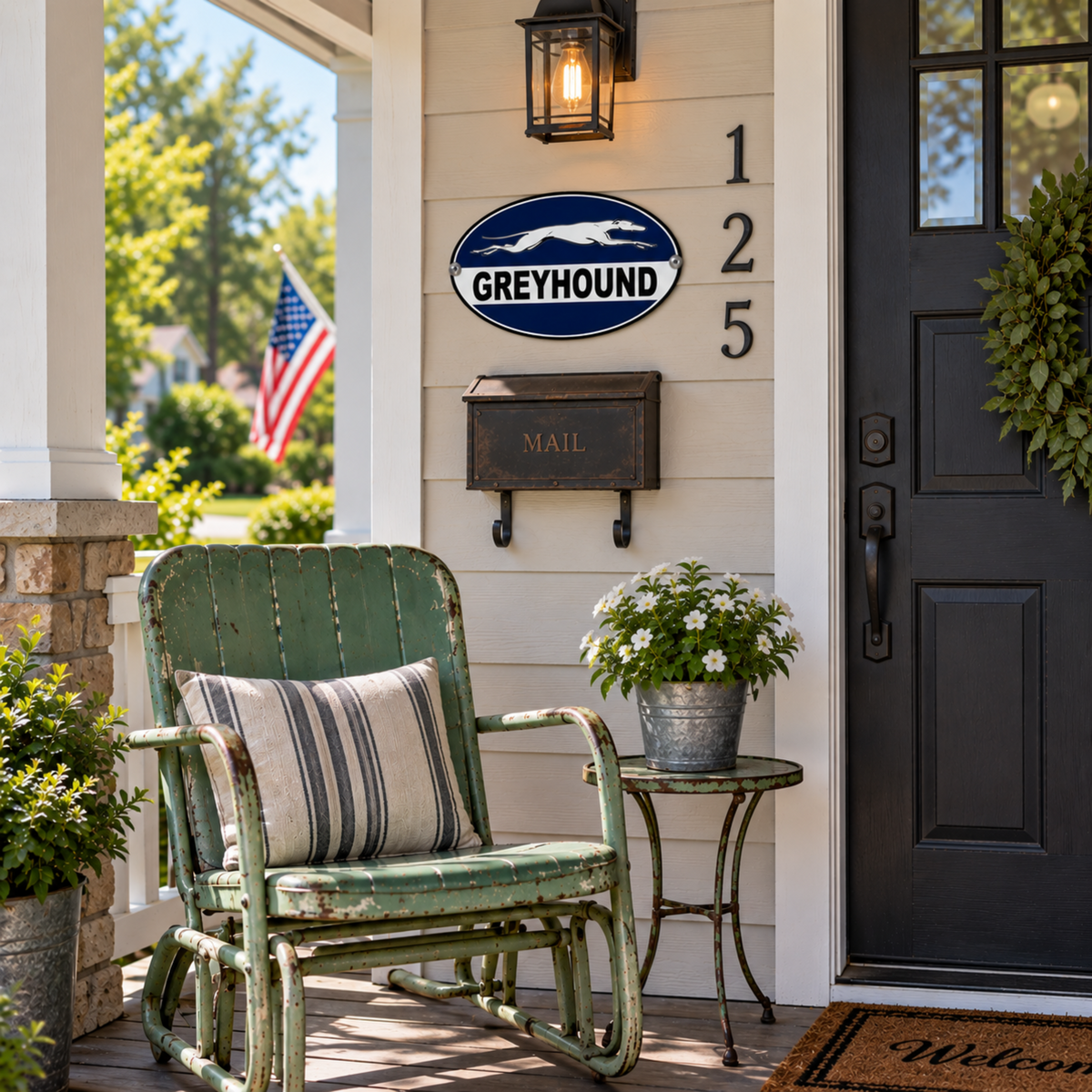 Greyhound Bus Station oval metal sign displayed beside a front door above a vintage wall-mounted mailbox and green porch chair.