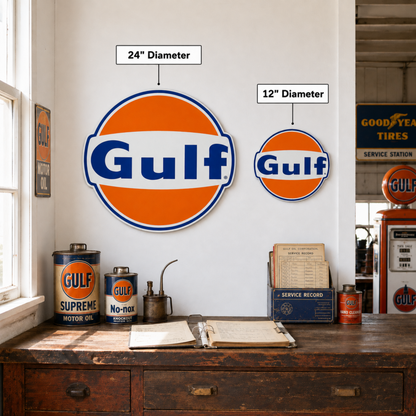 Gulf Gas & Oil embossed round aluminum signs in 12" and 24" sizes displayed together on a wall above a vintage garage workbench.