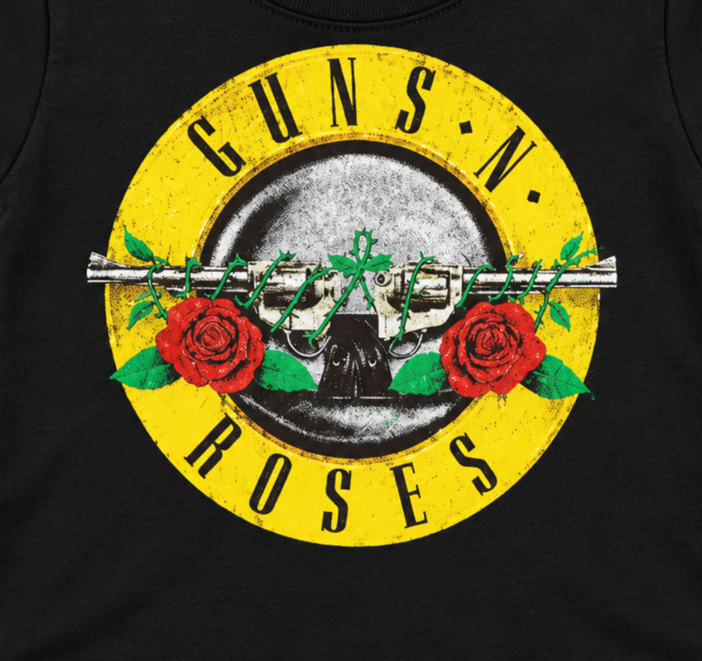 Close-up of the Guns N' Roses Double Guns graphic with crossed revolvers, red roses, and yellow band lettering on a black infant T-shirt.