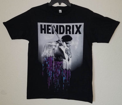 Black “Jimi Hendrix – Purple Drip” unisex T-shirt featuring Hendrix with guitar and a dripping purple-blue gradient design, Small–3XL.