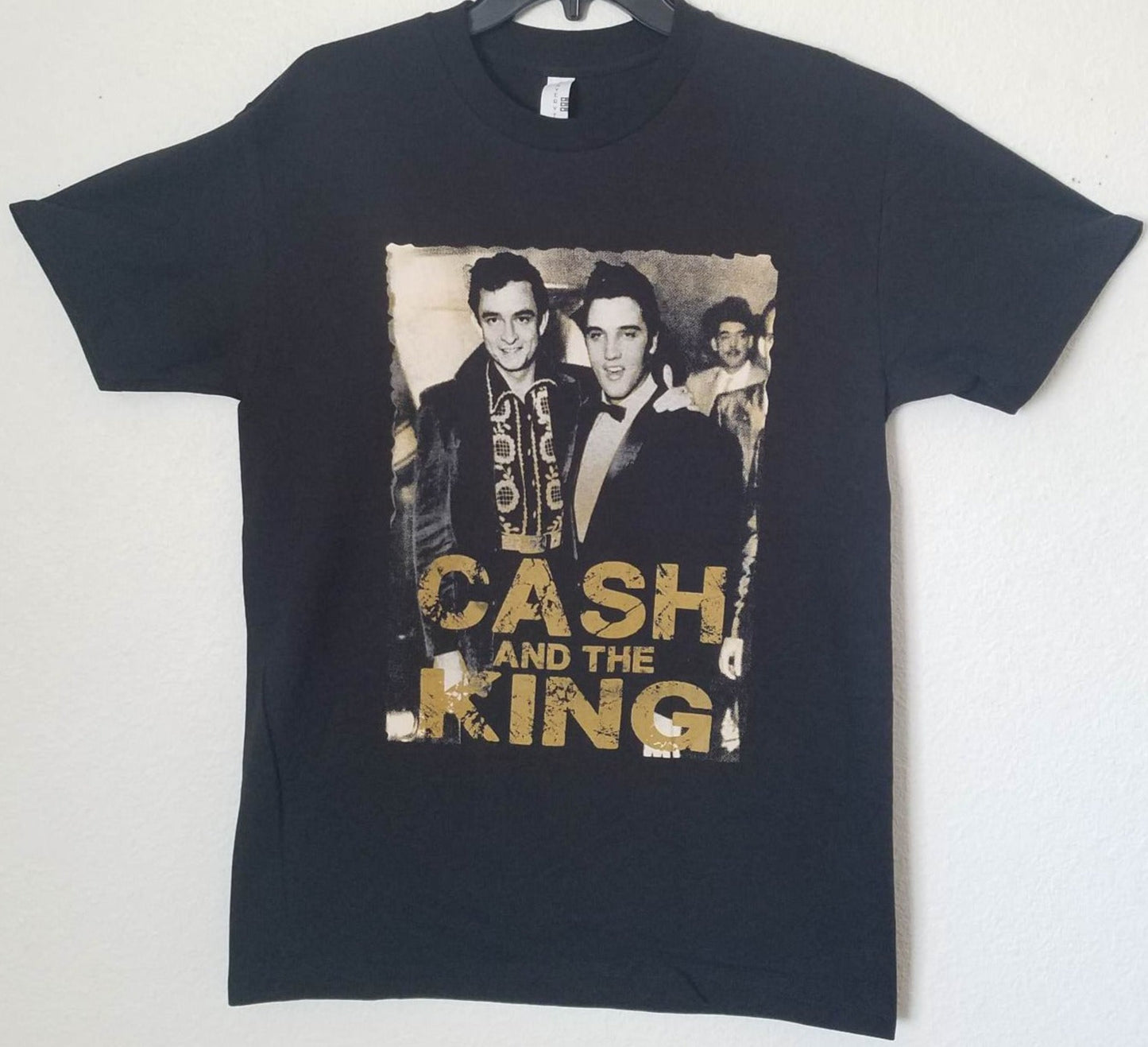 Front view of Johnny Cash and Elvis Presley Cash and the King graphic T-shirt featuring vintage black and white photo with gold lettering printed in authentic silkscreen on black cotton tee