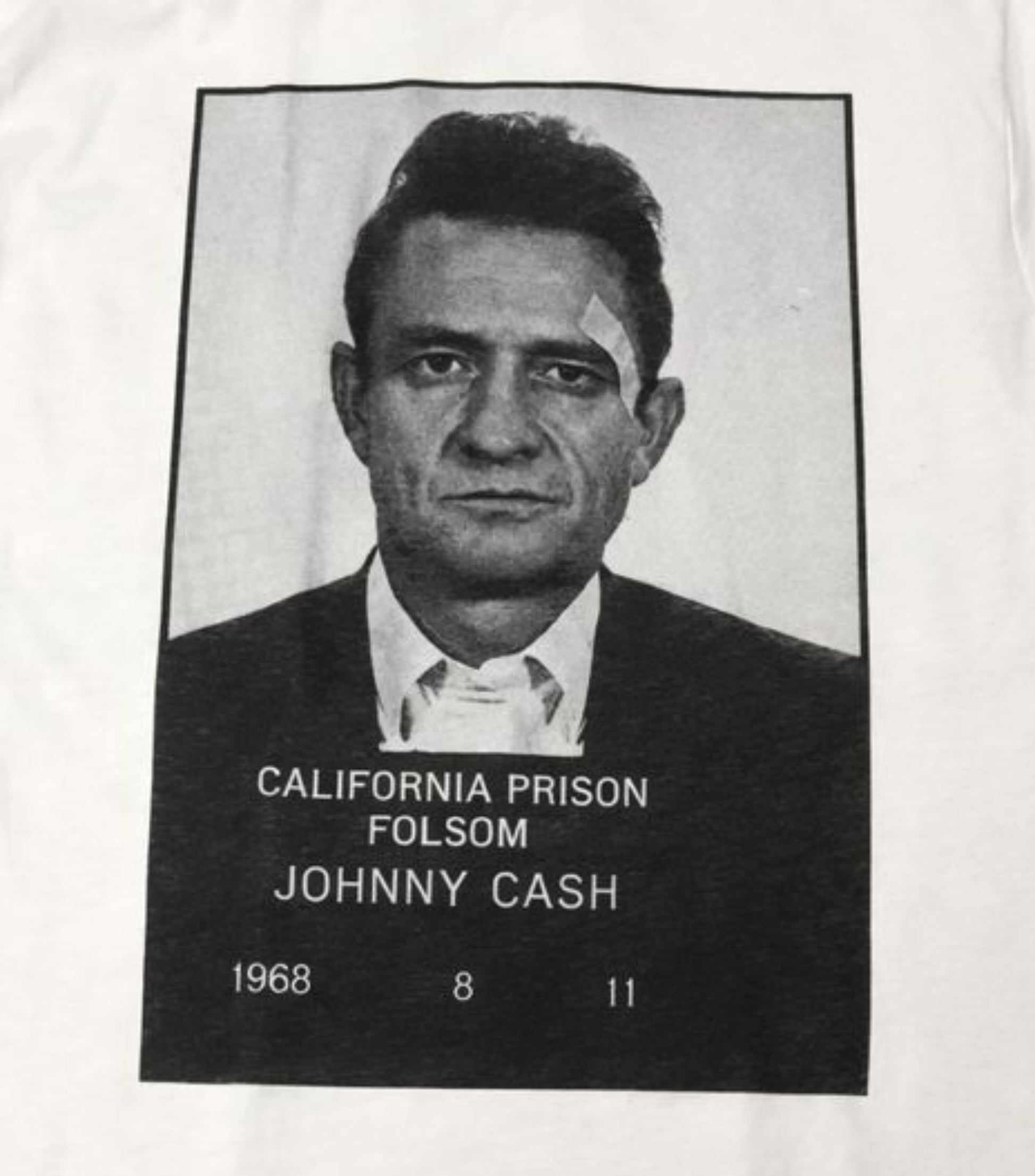 Unisex “Johnny Cash – Folsom Prison 1968” T-shirt featuring the classic black-and-white mugshot print, vintage music apparel in sizes Small–2XL.