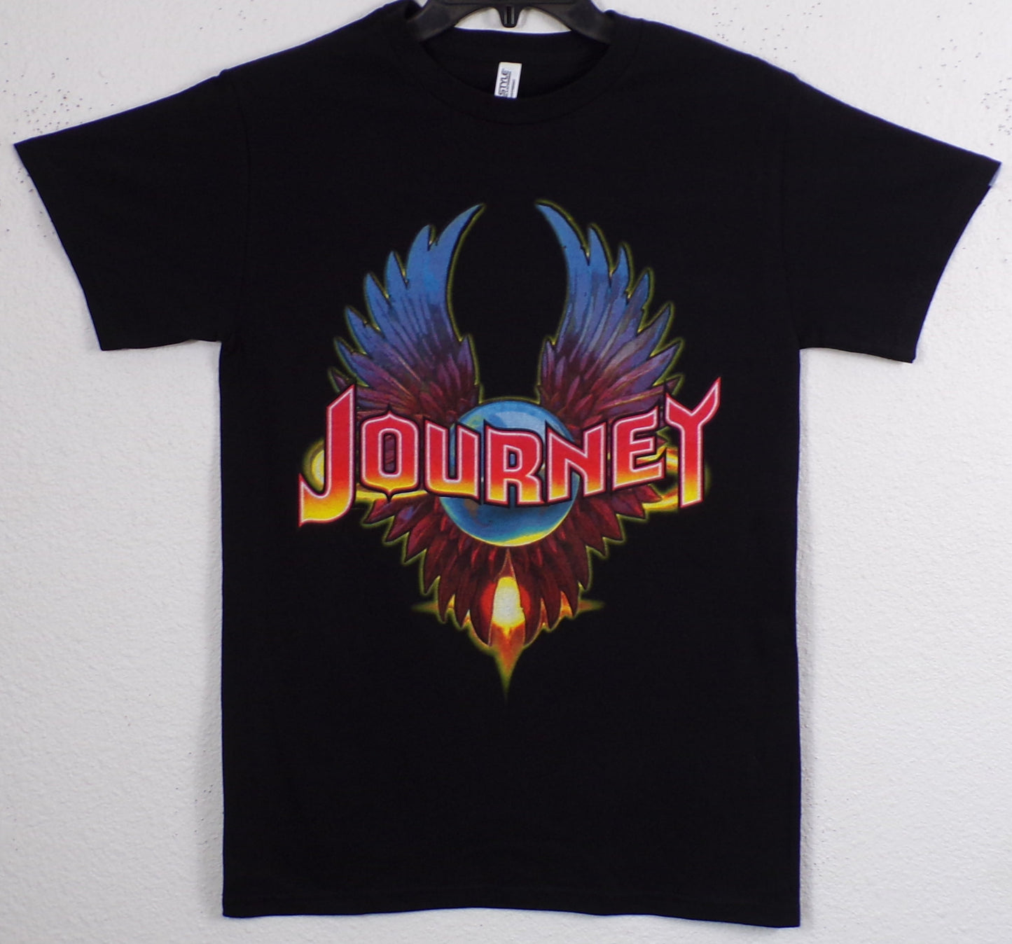 Black “Journey – Eagle Wings” T-shirt featuring the band’s iconic winged logo in bright, colorful silkscreen print.