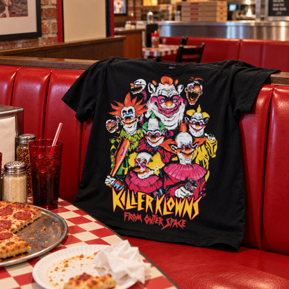 Killer Klowns from Outer Space black graphic T-shirt displayed over a red pizzeria booth, featuring Shorty, Rudy, Jumbo, Spikey, Fatso/Chubby and Slim.