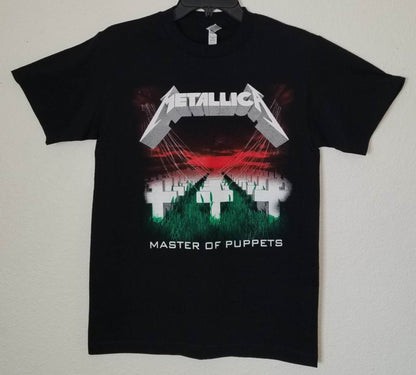 Front view of Metallica Master of Puppets graphic T-shirt featuring crosses field and red sky album artwork on black tee