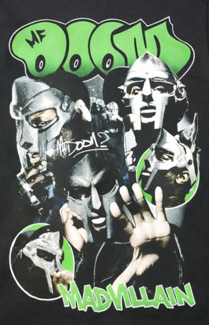 Black unisex “MF DOOM – Madvillain” T-shirt featuring green graffiti lettering and a collage of the masked rapper in multiple poses, available in Small–3XL.