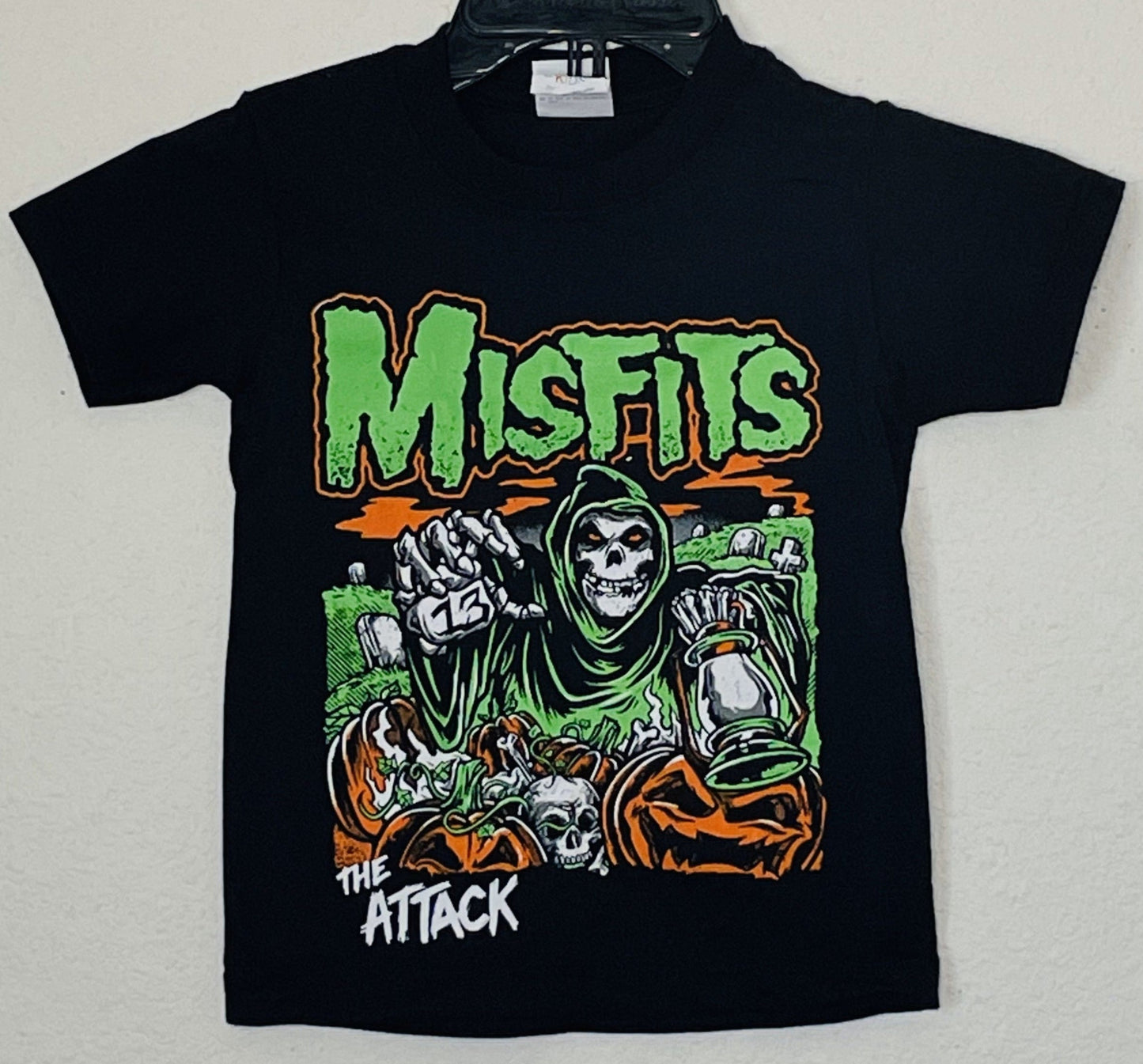 Misfits The Attack Youth T-Shirt – Unisex, featuring iconic punk rock graphics. Celebrating the collaboration between The Misfits, pioneers of horror-punk, and The Attack. Available in sizes XS-XL.
