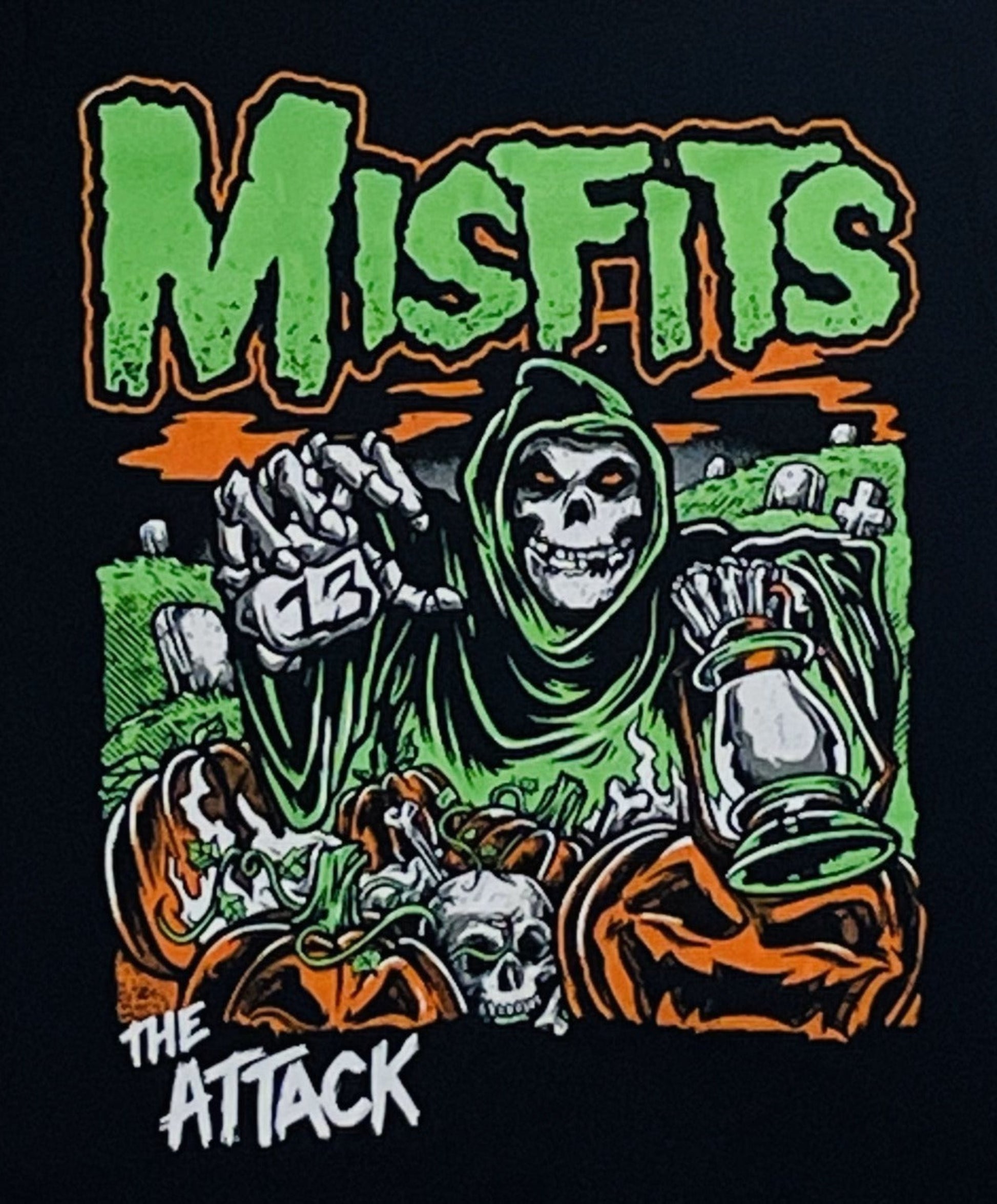Misfits The Attack Youth T-Shirt – Unisex, featuring iconic punk rock graphics. Celebrating the collaboration between The Misfits, pioneers of horror-punk, and The Attack. Available in sizes XS-XL.