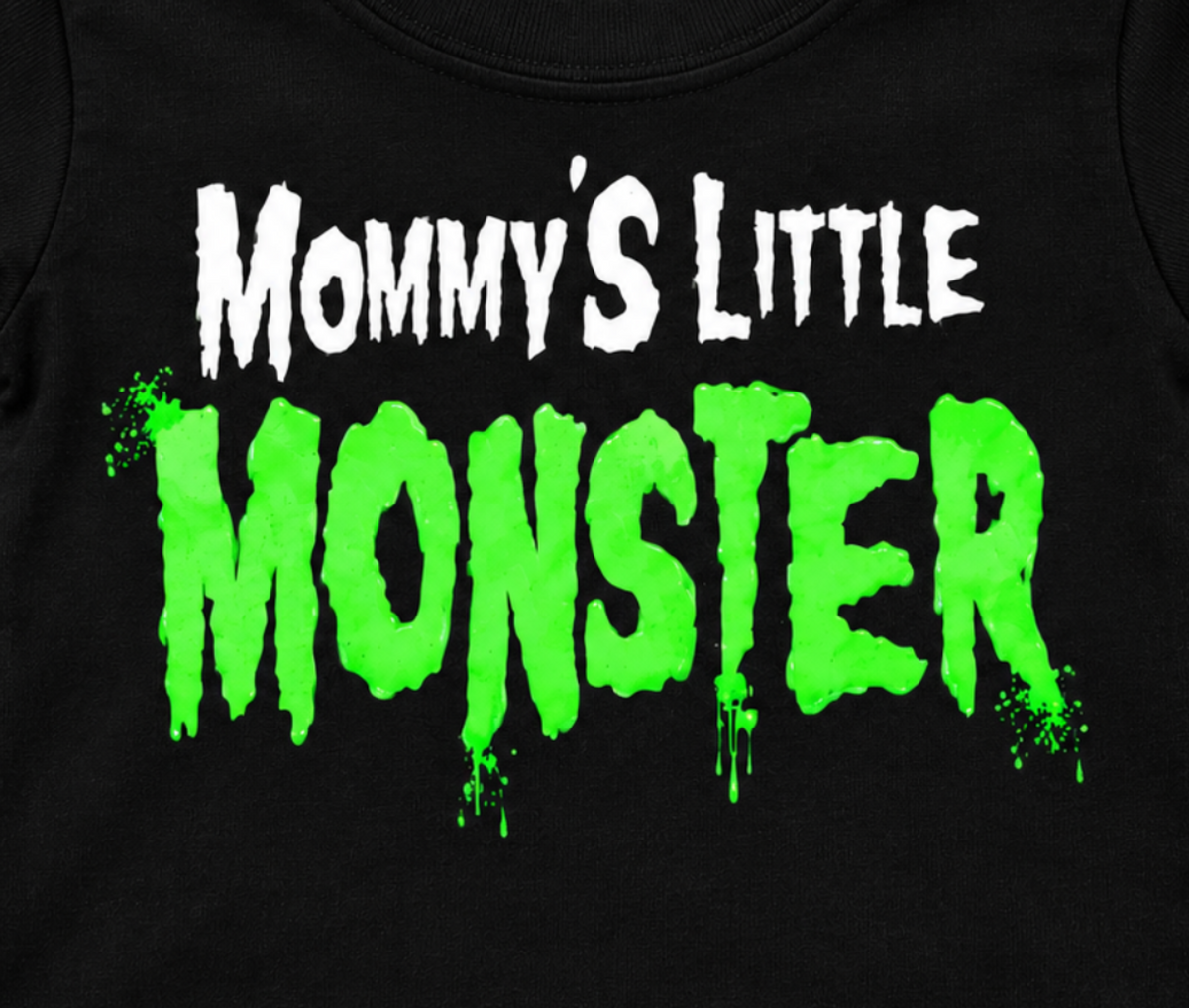 Close-up of the Mommy's Little Monster infant shirt design with white Mommy's Little text and bright green dripping Monster lettering.