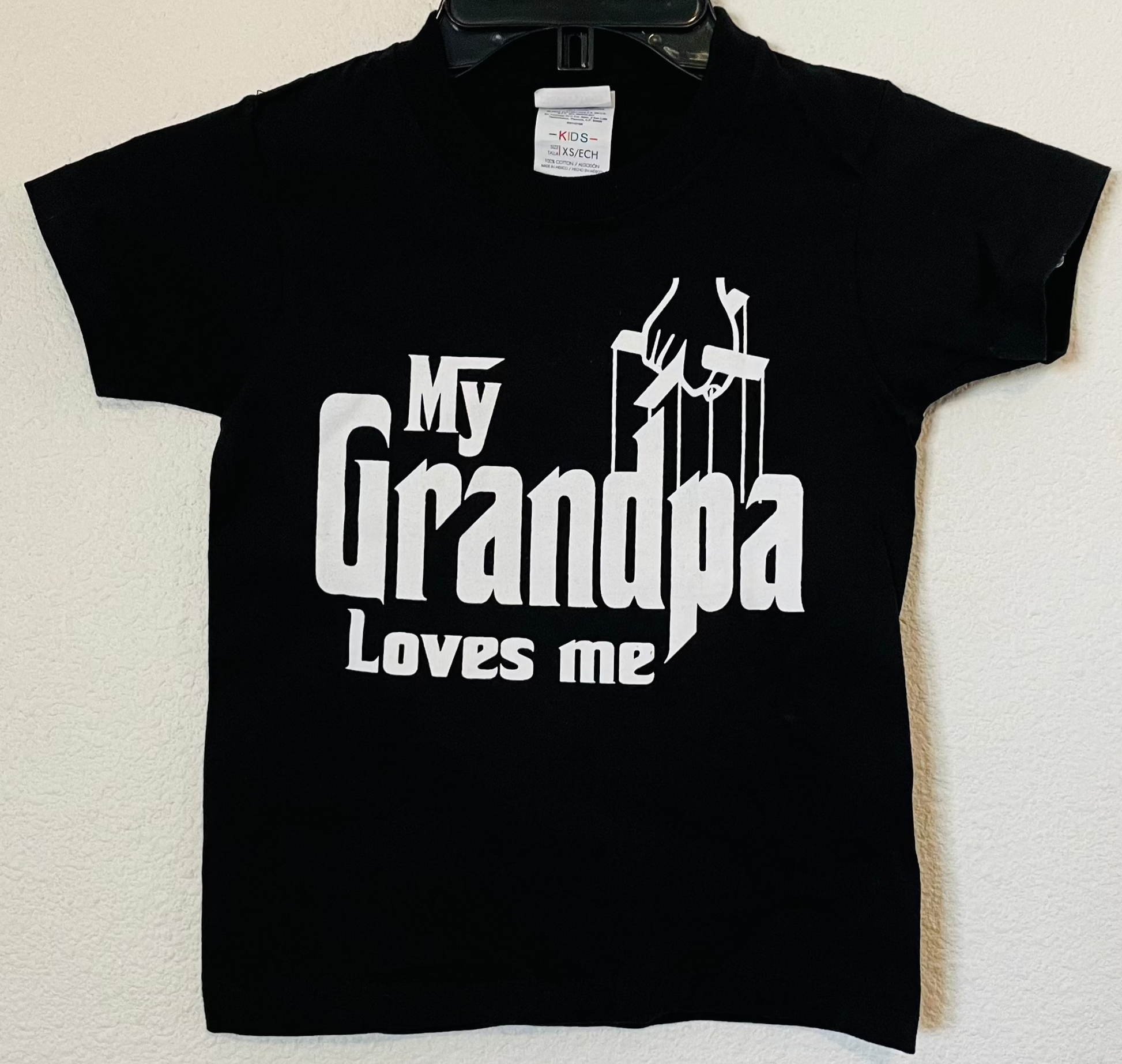Youth-sized t-shirt featuring a 'My Grandpa Loves Me' design with a Godfather-themed graphic. . Available in sizes XS-XL.