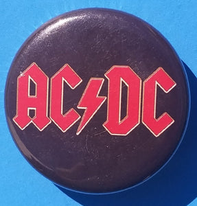 New AC/DC Button Set Of 7 Fashion Buttons Are 1.25" Inches In Size. Set Includes- 1. AC/DC Back In Black 2. AC/DC Brown Cannon 3. AC/DC Hells Bells 4. AC/DC Red Letter Logo On Black 5. AC/DC Red Letters With Face 6. AC/DC Stiff Upper Lip 7. AC/DC Who Made Who