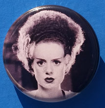 Load image into Gallery viewer, new bride of frankenstein button set of 7 fashion buttons are 1.25 inches in size Set Includes Bride of Frankenstein Bout To Kiss Bride of Frankenstein Couple In Heart Bride of Frankenstein Couple Sharing A Drink Bride of Frankenstein Front View Bride of Frankenstein Hands Over Breast Bride of Frankenstein Side View Frankenstein With Wrench tv movie horror
