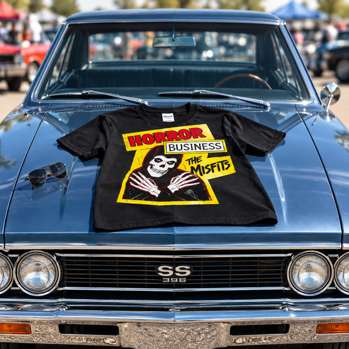 Black Papa Roach Infest Cockroach graphic T-shirt displayed across the hood of a classic Chevrolet, featuring the distressed white cockroach design and band name.