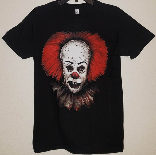 Pennywise IT Tim Curry horror graphic T-shirt featuring a close-up menacing grin design on black unisex cotton shirt S–3XL