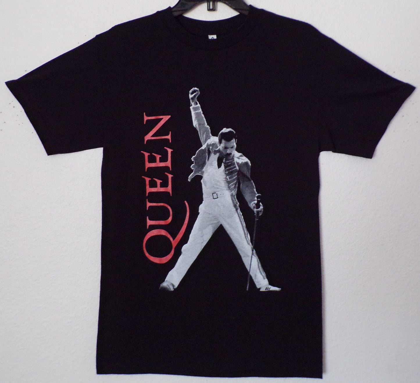 Front view of Queen Freddie Mercury graphic T-shirt featuring live performance pose with microphone on black tee