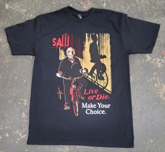 Black Saw t-shirt featuring Billy the Puppet on a tricycle with “Live or Die, Make Your Choice” text – Unisex Silkscreen