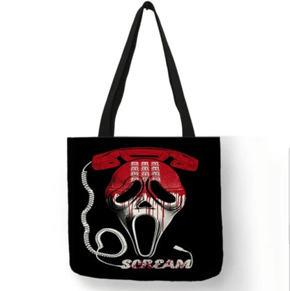 Black double-sided Scream canvas tote bag featuring the Ghostface mask beneath a red vintage telephone, a coiled phone cord, and Scream lettering.